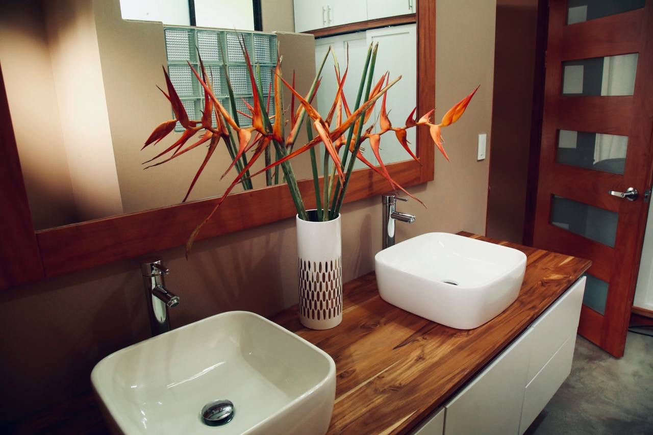 Bathroom with bird of paradise flowers and vessel sinks