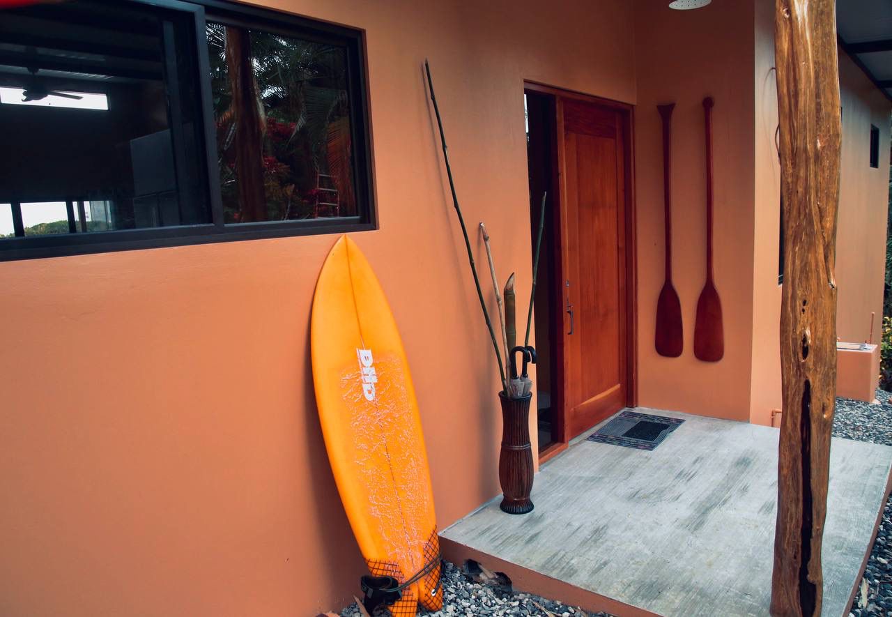 Front door entrance with surfboard and paddle decor