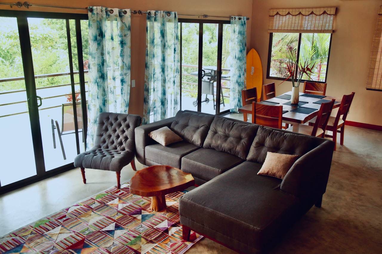 Spacious living room with sectional sofa and colorful rug